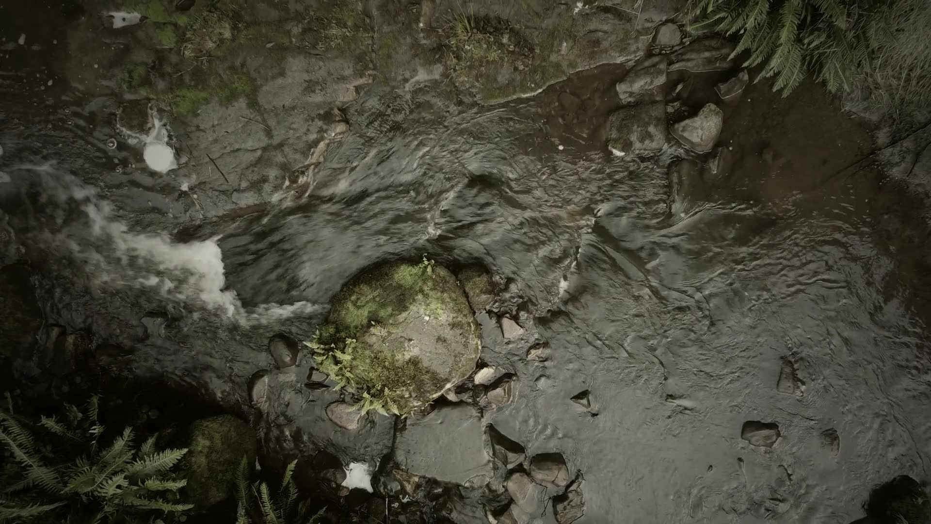 Looking straight down on a creek running over stone, then cloud coming over a hillside of paddocks